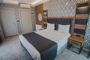 A bed or beds in a room at Prusias Otel