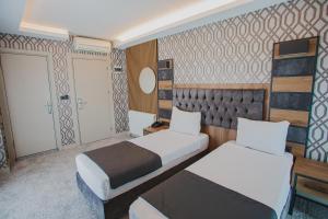 A bed or beds in a room at Prusias Otel