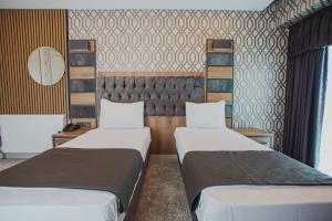 A bed or beds in a room at Prusias Otel