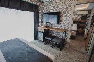 A bed or beds in a room at Prusias Otel