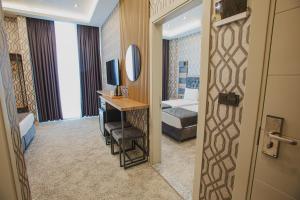 A bed or beds in a room at Prusias Otel