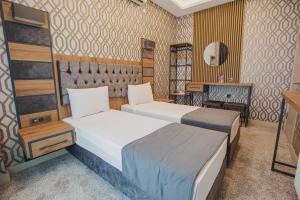 A bed or beds in a room at Prusias Otel