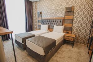 A bed or beds in a room at Prusias Otel