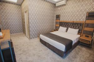 A bed or beds in a room at Prusias Otel