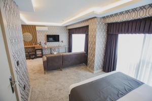 A bed or beds in a room at Prusias Otel