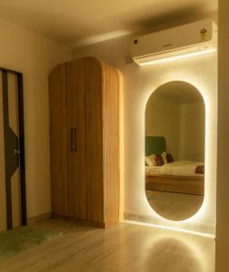 a bedroom with a large mirror and a bed at The Lavish Stay in Varanasi