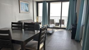 a dining room with a table and a living room with a view at Oceanfront Penthouse, Two-Story, 3 Bedrooms in Myrtle Beach