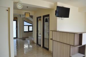 a living room with a flat screen tv on a wall at Vila RAZA - locatie centrala in Eforie Nord