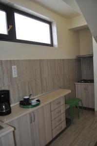 a kitchen with a counter and a window at Vila RAZA - locatie centrala in Eforie Nord