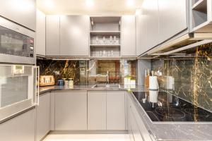 a kitchen with white cabinets and stainless steel appliances at The Percy's in Oxford