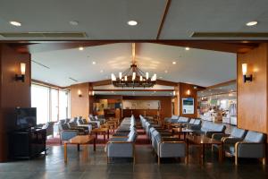 a restaurant with chairs and tables and a chandelier at Midagahara Hotel in Tateyama