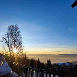 a view of the sun rising over the clouds at Fortuna Royal in Kopaonik +4 photos