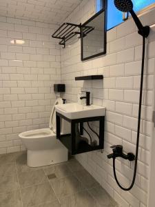 a bathroom with a sink and a toilet at 藍貝島潛水背包旅宿一館 Lambay Island Dive Hostel I in Xiaoliuqiu +9 photos