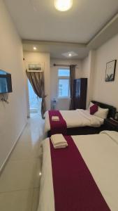 Postel nebo postele na pokoji v ubytování Conico Hotel at Dalat