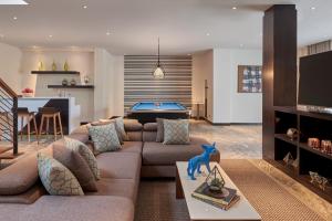 a living room with a couch and a pool table at Renaissance Bali Uluwatu Resort & Spa in Uluwatu