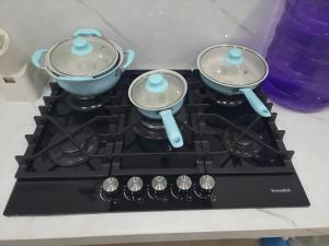 a stove top with two pots on top of it at Danna Suite 1 Familiar in San Cristobal