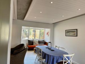 a dining room with a blue table and chairs at Central Apartment near Jetty Swakopmund in Swakopmund