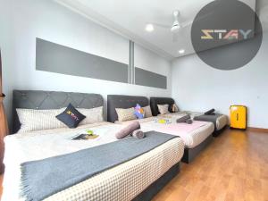 a bedroom with two beds with pillows at Platino 4Bedrooms Paradigm Mall Netflix By STAY in Johor Bahru +79 photos