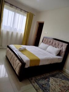 a large bed in a bedroom with a large window at Ce Les Homes in Eldoret
