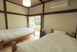 Postel nebo postele na pokoji v ubytování Kitakaruizawa Isshoan ~北軽井沢 一菖庵~ + 26 fotografií