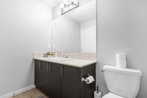 a bathroom with a sink and a toilet and a mirror at Private Master Bed Room SPRING in Edmonton +37 photos