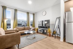 a living room with a couch and a tv at Private Master Bed Room SPRING in Edmonton
