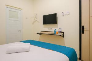 Postel nebo postele na pokoji v ubytování Sans Hotel Beskalan Malioboro