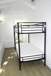 泰尔斯贝斯delightful vacation Villa Crystal St Martin的白色客房内的一张黑色双层床 更多12张照片