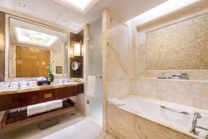 a bathroom with a tub and a large mirror at The Ritz-Carlton, Chengdu in Chengdu