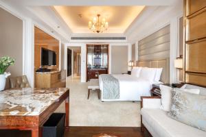 a hotel room with a bed and a couch at The Ritz-Carlton, Chengdu in Chengdu