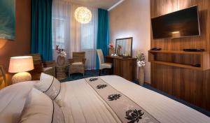 オストラヴァにあるサレザ ホテルのベッドとテレビが備わるホテルルームです。