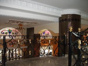 a staircase with a black wrought iron railing at Marmaray Hotel in Istanbul