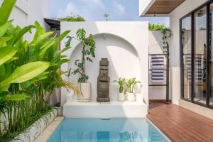 a pool in a house with plants at Bali Best - Kept Secret - Brand New Villa with Private Pool - Steps from the Action in Seminyak