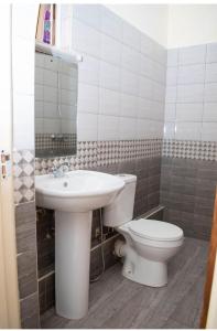 a bathroom with a toilet and a sink at Ce Les Homes in Eldoret
