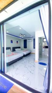 a room with two beds and a large window at Level UP pool villa Rayong in Rayong +45 photos