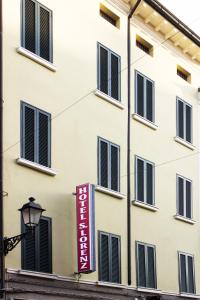 a building with a sign on the side of it at Hotel Saint Lorenz in Reggio Emilia