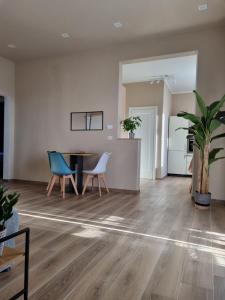 an empty living room with a table and chairs at Alemanni54 - Apartment in Bologna