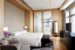 a bedroom with a large bed and a television at Bangkok Marriott Hotel Sukhumvit in Bangkok