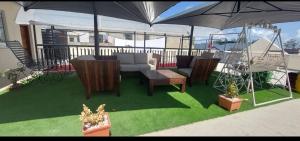 a patio with a table and chairs and an umbrella at Mtwapa june apartment 3 in Mtwapa