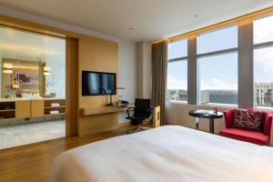 a hotel room with a bed and a television at Bangkok Marriott Hotel Sukhumvit in Bangkok