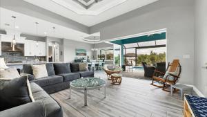 a living room with a couch and a table at Luxury Contemporary Style House on Charlotte Harbor Area Charlotte County House 5841 in Placida