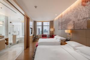 a hotel room with four beds and a bathroom at Bangkok Marriott Hotel Sukhumvit in Bangkok