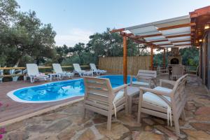 a patio with chairs and a swimming pool at Ceren Villa Akyaka Daily Weekly Rentals in Mugla