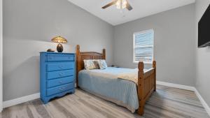 a bedroom with a blue bed and a blue dresser at Luxury Contemporary Style House on Charlotte Harbor Area Charlotte County House 5841 in Placida +32 photos