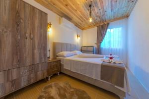 a bedroom with a large bed with a wooden ceiling at Ceren Villa Akyaka Daily Weekly Rentals in Mugla +44 photos
