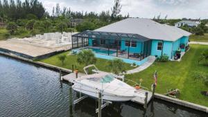 a boat is docked at a house on the water at Luxury Contemporary Style House on Charlotte Harbor Area Charlotte County House 5841 in Placida