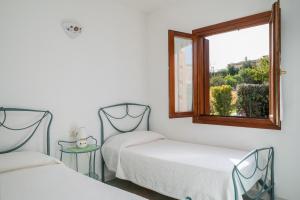 Postel nebo postele na pokoji v ubytování Villetta Bouganville + 84 fotografií