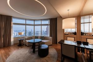 a living room with a couch and a table at Bangkok Marriott Hotel Sukhumvit in Bangkok