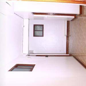 a room with a white wall and a window at Mtwapa june apartment 2 in Mtwapa +1 photo