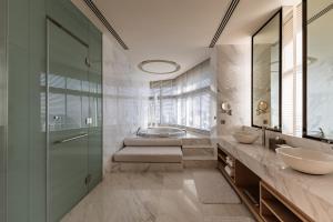 a bathroom with two sinks and a glass shower at Bangkok Marriott Hotel Sukhumvit in Bangkok +37 photos